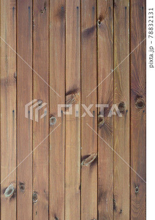 Close up of brown wooden fence panels. Many vertical wooden planks 78832131