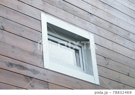 Plastic PVC window in new modern passive wooden house facade wall 78832469