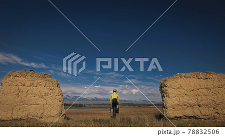 The woman travel on mixed terrain cycle touring with bikepacking. The traveler journey with bicycle bags. Sport tourism bikepacking. The woman travel on mixed terrain cycle touring with bikepacking. The traveler journey with bicycle bags. Sport tourism bikepacking. 78832506