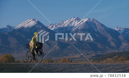 The woman travel on mixed terrain cycle touring with bikepacking. The traveler journey with bicycle bags. Sport tourism bikepacking. 78832538
