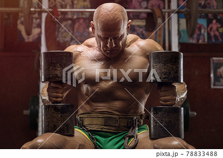 old fashion bodybuilder arm exercises in gym 78833488