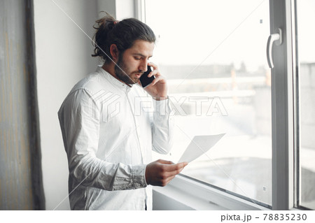 Stylish young businessman working with documents 78835230