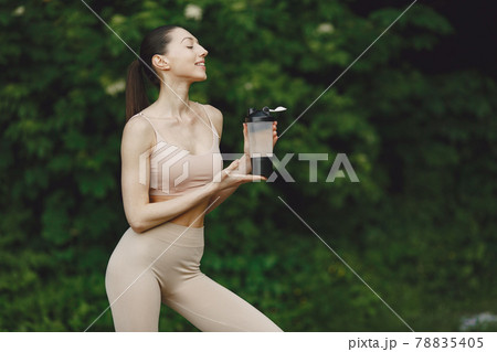 Woman practicing advanced yoga in a summer park Woman practicing advanced yoga in a summer park 78835405
