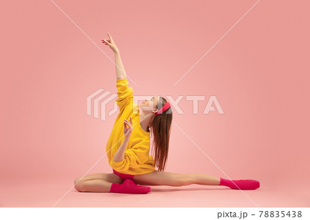 Flexible young beautiful girl, female ballet dancer training isolated over pink background. 78835438