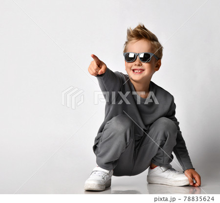Little fashion boy squatting pointing finger 78835624