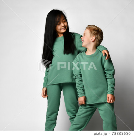 Portrait of smiling asian preteen girl hugging Portrait of smiling asian preteen girl hugging 78835650