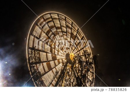 Ferris wheel in motion at the amusement park, night illumination. Long exposure 78835826
