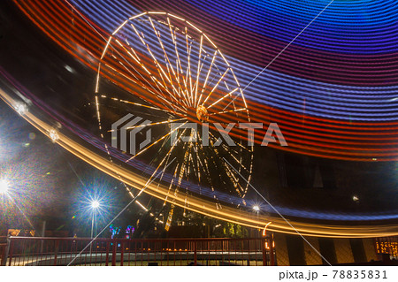Ferris wheel in motion at the amusement park, night illumination. Long exposure 78835831