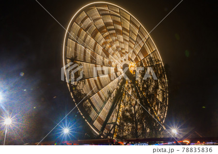 Ferris wheel in motion at the amusement park, night illumination. Long exposure 78835836