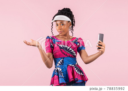 Beautiful afro american woman with visor shrugging at the camera: Technology and lifestyle concept. Beautiful afro american woman with visor shrugging at the camera: Technology and lifestyle concept. 78835992