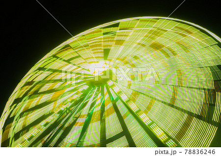 Ferris wheel in motion at the amusement park, night illumination. Long exposure Ferris wheel in motion at the amusement park, night illumination. Long exposure 78836246