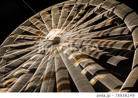 Ferris wheel in motion at the amusement park, night illumination. Long exposure 78836249