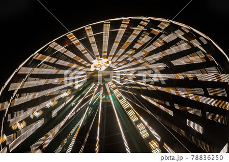 Ferris wheel in motion at the amusement park, night illumination. Long exposure 78836250