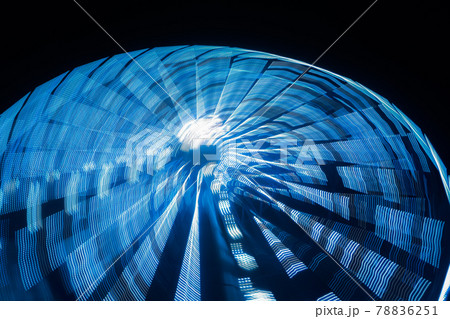 Ferris wheel in motion at the amusement park, night illumination. Long exposure Ferris wheel in motion at the amusement park, night illumination. Long exposure 78836251