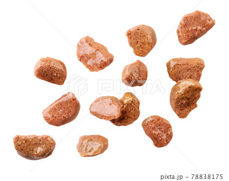 Cat food pieces of meat are flying on a white, isolated 78838175