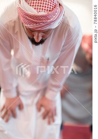 group of muslim people praying namaz in mosque. 78840016