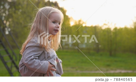 Little girl in the evening summer sunset. 78840565