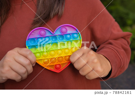 Woman using pop it fidget toy closeup. 78842161
