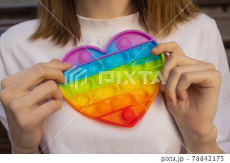 Woman using pop it fidget toy closeup. 78842175