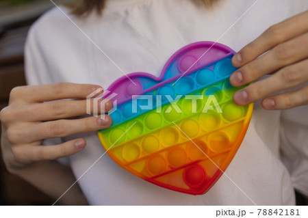 Woman using pop it fidget toy closeup. 78842181