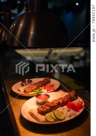 Delicious seekh kabab served in plate at table. Delicious seekh kabab served in plate at table. 78842197