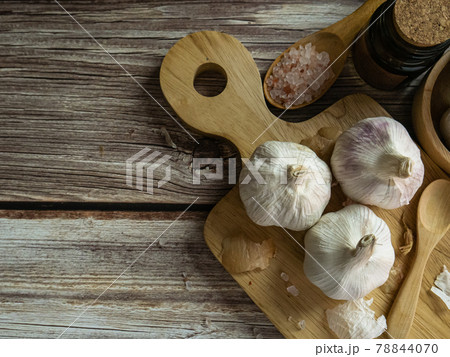 The garlic on wood table for food or cooking concept. 78844070