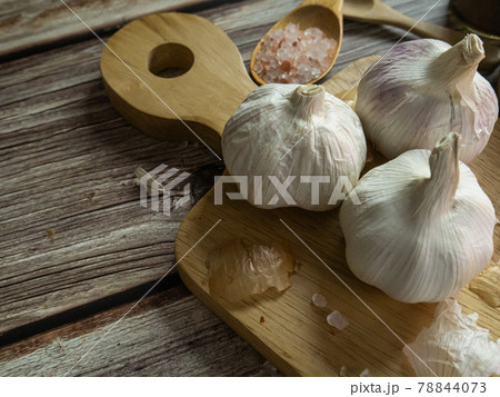 The garlic on wood table for food or cooking concept. The garlic on wood table for food or cooking concept. 78844073