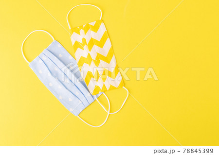 Eco-friendly reusable cloth protective mask yellow background. Homemade breathing mask, protection against corona virus 78845399