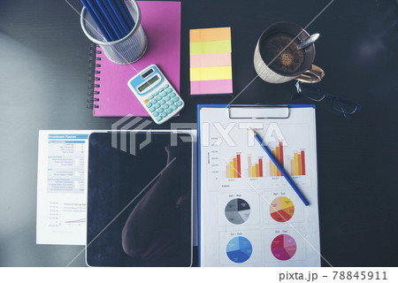 Office laptop business financial document chart and graph on wooden table with coffee cup. Flat lay notebook computer laptop on office desk. No people business graph chart mockup on business workspace 78845911