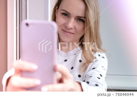 Blonde young girl taking selfie. Video call. Online education. Work from home. Woman holding smartphone. Phone call. Recording new vlog for her channel. Blogger 78846044