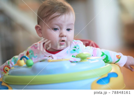 baby learning to walk in walker baby learning to walk in walker 78848161