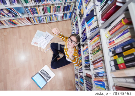 the student uses a notebook and a school library the student uses a notebook and a school library 78848462
