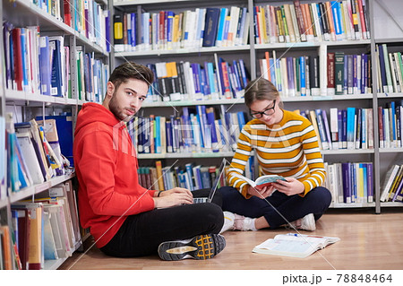 the students uses a notebook, laptop and a school library 78848464