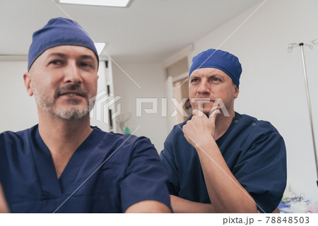 Orthopedist doctor team examining digital X-ray picture in clinic or hospital 78848503