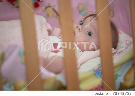 cute little baby in bed trying to sleep 78848755