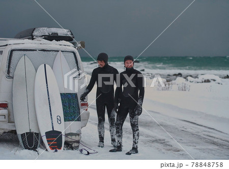 Arctic surfers in wetsuit after surfing by minivan 78848758