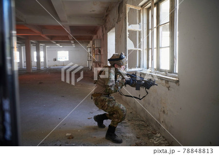 soldier in action near window changing magazine and take cover soldier in action near window changing magazine and take cover 78848813