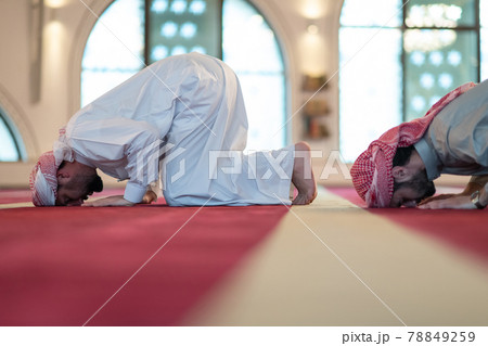 group of muslim people praying namaz in mosque. 78849259