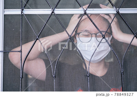 Portrait of young Asian woman having headache, quarantine herself in her home in covid-19 pandemic outbreak. Portrait of young Asian woman having headache, quarantine herself in her home in covid-19 pandemic outbreak. 78849327