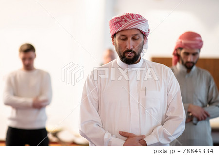 group of muslim people praying namaz in mosque. 78849334
