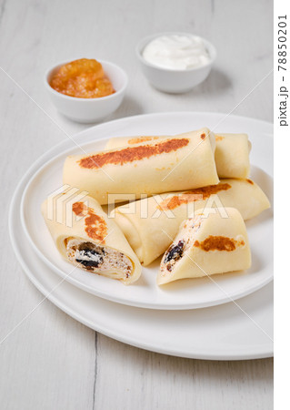 Thin pancakes stuffed with curd and raisins 78850201