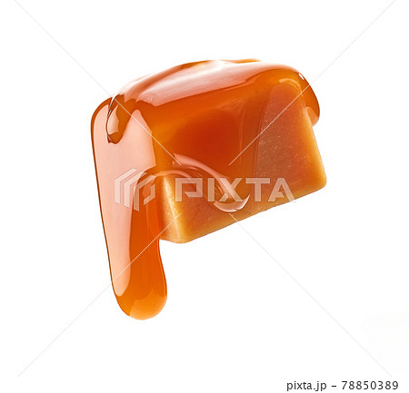 caramel sauce flowing on flying caramel candy 78850389