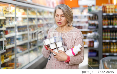 Amazed senior female reading contents of products 78850645