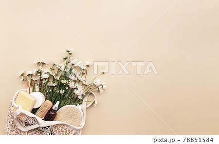 Eco friendly beige flat lay with shopping bag, flowers, bath accessories Eco friendly beige flat lay with shopping bag, flowers, bath accessories 78851584