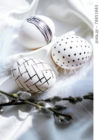 Trendy colored stylish Natural easter eggs, feathers, pussy willow branches on rustic cloth on white silk fabric. Flat lay. Easter still life 78851683