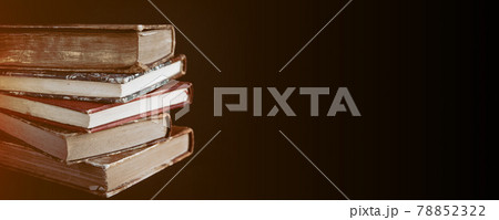 Stack of old books on black background banner Stack of old books on black background banner 78852322