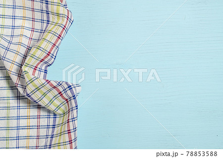 crumpled napkin in cage on a blue wooden background. crumpled napkin in cage on a blue wooden background. 78853588