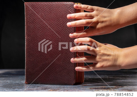 The childs hands stretching to the old book. The concept of thirst for knowledge The childs hands stretching to the old book. The concept of thirst for knowledge 78854852