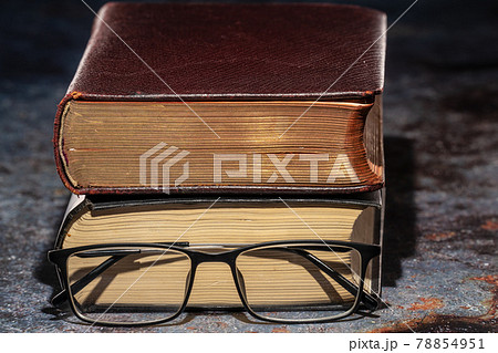 An old book with glasses. Knowledge and Education Concept An old book with glasses. Knowledge and Education Concept 78854951