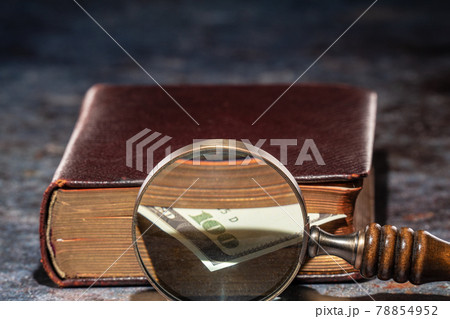 One hundred dollar bookmark note in an old book One hundred dollar bookmark note in an old book 78854952